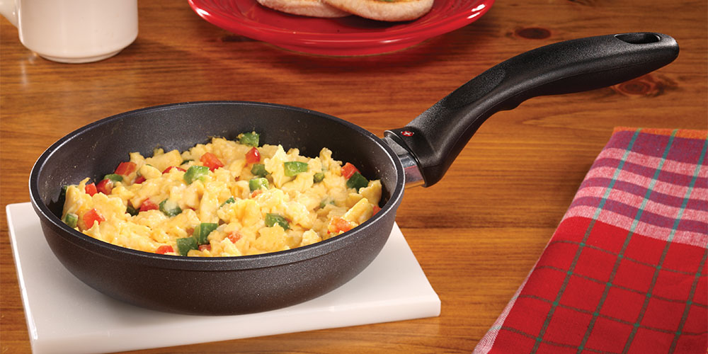 Scrambled eggs with vegetables in a fry pan