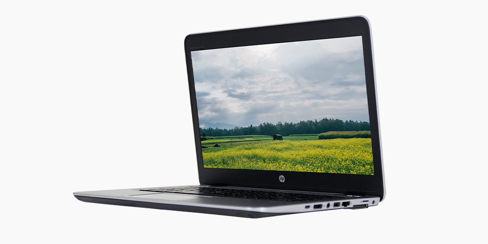 An HP laptop in black showing a field screen saver 