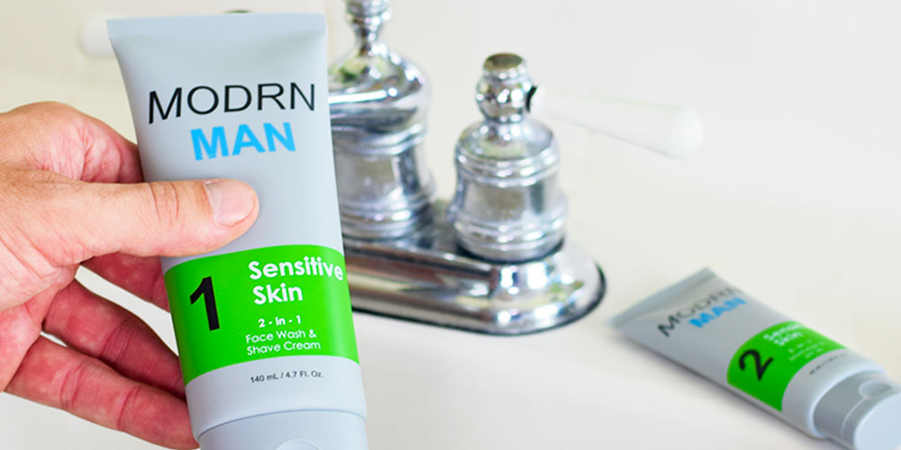 A person holding a bottle of Modrn Man face wash